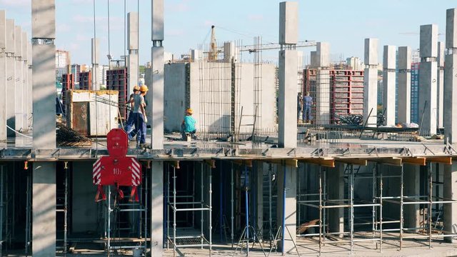 Many people work on a contruction site.