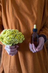 The Helichrysum Arenarium golden grass on the wooden background.