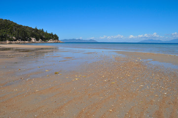 Beach scene and coastal view at low tide, Geoffrey Bay, Magnetic Island, Queensland, Australia