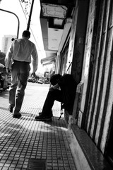 Sad man sitting on a curb