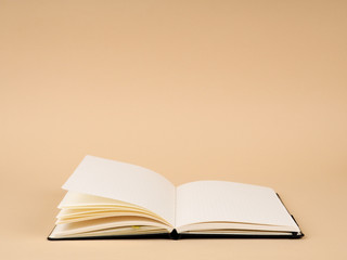 Blank open notepad. On vintage wooden background.