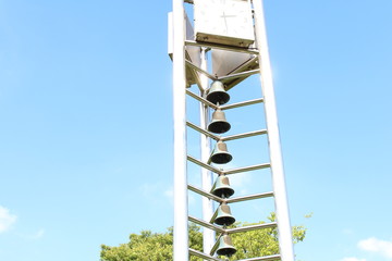 bells and a clock in a park
