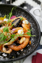 Fancy funnel cake with goat cheese, powdered sugar, edible flowers, and honey, top view, modern brunch