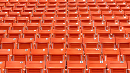 Naklejka premium Stadium seat rows in sports arena for football or soccer game, public theatre, concert hall amphitheater with empty red audience chair for outdoor sporty recreational background 