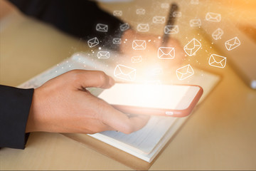 Business people check email communication information (Mail icon) with a modern and fast smartphone connected to the 5G network