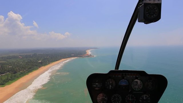 Helicopter view inside a Robinson R44 in flight 