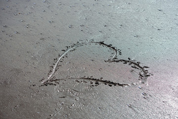 Heart drawn in the wet sand at Broad Haven beach in Pembrokeshire