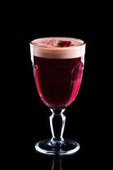 Glass of hot rose burgeon punche isolated on black
