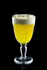 Glass of hot ginger grog isolated on black