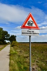  Warning sign on the heath: beware of sunning adders