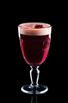Glass of hot rose burgeon punche isolated on black