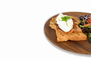 Homemade meal, Organic egg benedict with fresh salad on wood plate for healthy breakfast in white background