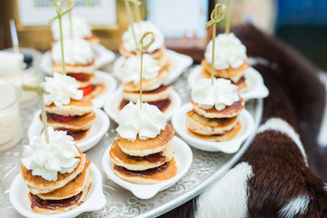 Small pancake Topped with whipped cream Buffet dessert at a party