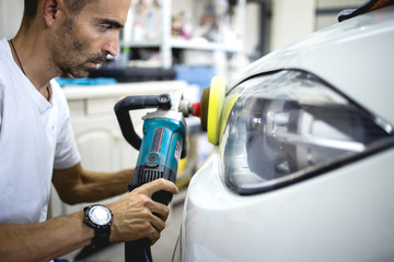 Naklejka na ściany i meble Car polishing details in workshop stock photo