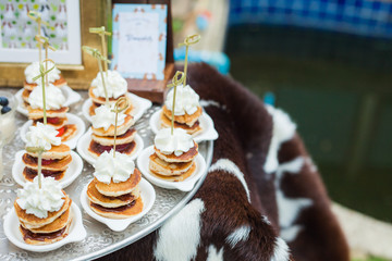 Small pancake Topped with whipped cream Buffet dessert at a party