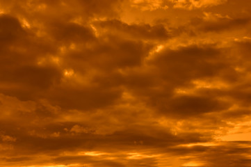 Obraz premium The sky at sunset. Cumulus clouds lit by the rays of the setting sun.