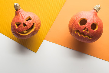 top view of ripe carved pumpkins on white background