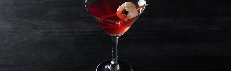 panoramic shot of red decorated Halloween cocktail on black background