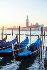 Fototapeta na wymiar Sunrise at Venice with gondola and island of st george view from the square San marco