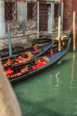 Fototapeta na wymiar Canal with gondolas in Venice, Italy. Postcard with Venice gondolas.