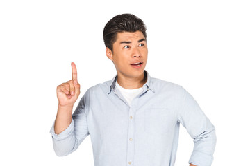 Fototapeta premium young asian man showing idea sign while looking away isolated on white