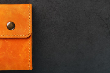 Brown purse, wallet made of genuine leather Nubuck on a dark background. Elements of leather craft products handmade