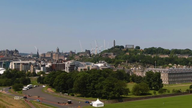 Aerial ascending view of Holyroodhouse palace and the Scottish Parliament in Edinburgh