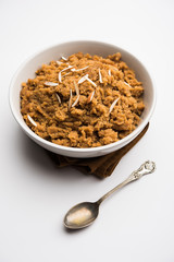 Wheat flour Halwa or Shira /  Atte ka Halva, Popular healthy dessert or breakfast menu from India. served in a bowl or plate. selective focus