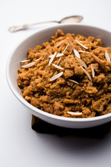 Wheat flour Halwa or Shira /  Atte ka Halva, Popular healthy dessert or breakfast menu from India. served in a bowl or plate. selective focus