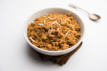 Wheat flour Halwa or Shira /  Atte ka Halva, Popular healthy dessert or breakfast menu from India. served in a bowl or plate. selective focus