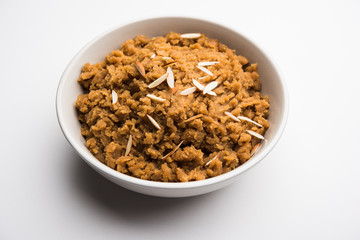 Wheat flour Halwa or Shira /  Atte ka Halva, Popular healthy dessert or breakfast menu from India. served in a bowl or plate. selective focus