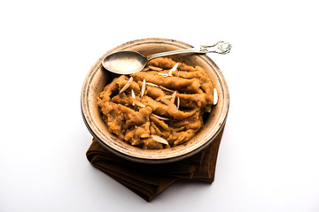 Wheat flour Halwa or Shira or porridge /  Atte ka Halva, Popular healthy dessert or breakfast menu from India. served in a bowl or plate. selective focus