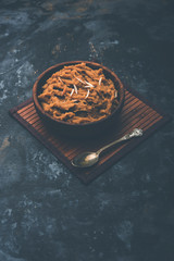 Wheat flour Halwa or Shira or porridge /  Atte ka Halva, Popular healthy dessert or breakfast menu from India. served in a bowl or plate. selective focus