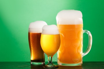 Golden beer in glass with foam, alcohol beverage,  lager pub.