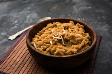 Wheat flour Halwa or Shira or porridge /  Atte ka Halva, Popular healthy dessert or breakfast menu from India. served in a bowl or plate. selective focus
