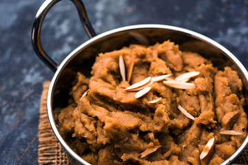 Wheat flour Halwa or Shira or porridge /  Atte ka Halva, Popular healthy dessert or breakfast menu from India. served in a bowl or plate. selective focus
