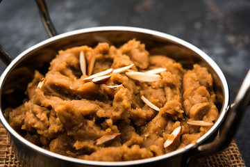 Wheat flour Halwa or Shira or porridge /  Atte ka Halva, Popular healthy dessert or breakfast menu from India. served in a bowl or plate. selective focus