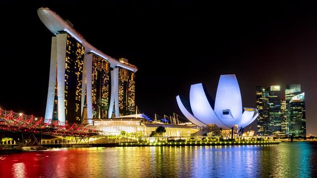 Time lapse of the Singapore at night time. Views of Marina Bay at night with colorful light from hotels and buildings around Marina Bay.