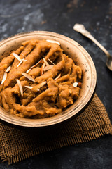 Wheat flour Halwa or Shira or porridge /  Atte ka Halva, Popular healthy dessert or breakfast menu from India. served in a bowl or plate. selective focus