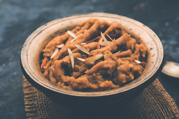 Wheat flour Halwa or Shira or porridge /  Atte ka Halva, Popular healthy dessert or breakfast menu from India. served in a bowl or plate. selective focus
