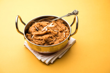 Wheat flour Halwa or Shira or porridge /  Atte ka Halva, Popular healthy dessert or breakfast menu from India. served in a bowl or plate. selective focus