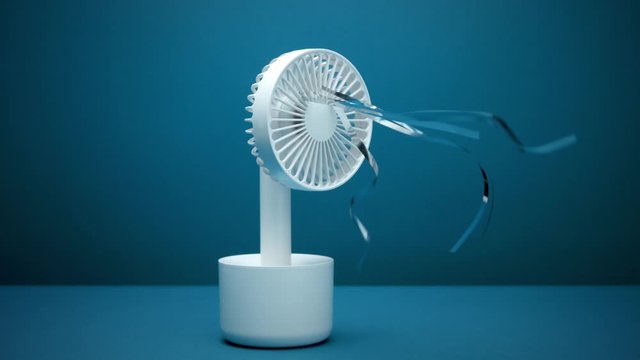 Slow motion from 60 fps little portable ventilator blows silver strips