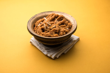 Wheat flour Halwa or Shira or porridge /  Atte ka Halva, Popular healthy dessert or breakfast menu from India. served in a bowl or plate. selective focus