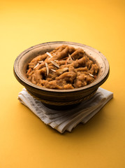 Wheat flour Halwa or Shira or porridge /  Atte ka Halva, Popular healthy dessert or breakfast menu from India. served in a bowl or plate. selective focus