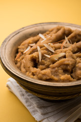 Wheat flour Halwa or Shira or porridge /  Atte ka Halva, Popular healthy dessert or breakfast menu from India. served in a bowl or plate. selective focus