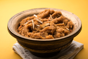 Wheat flour Halwa or Shira or porridge /  Atte ka Halva, Popular healthy dessert or breakfast menu from India. served in a bowl or plate. selective focus