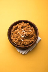 Wheat flour Halwa or Shira or porridge /  Atte ka Halva, Popular healthy dessert or breakfast menu from India. served in a bowl or plate. selective focus
