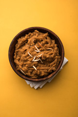 Wheat flour Halwa or Shira or porridge /  Atte ka Halva, Popular healthy dessert or breakfast menu from India. served in a bowl or plate. selective focus