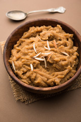 Wheat flour Halwa or Shira or porridge /  Atte ka Halva, Popular healthy dessert or breakfast menu from India. served in a bowl or plate. selective focus