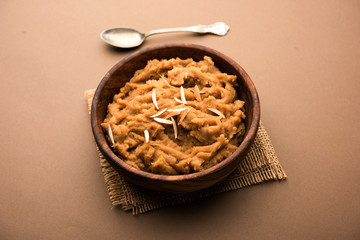 Wheat flour Halwa or Shira or porridge /  Atte ka Halva, Popular healthy dessert or breakfast menu from India. served in a bowl or plate. selective focus